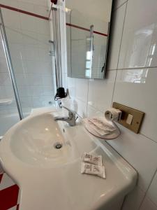 a white sink in a bathroom with a mirror at D'Aversa Rooms in Marineo