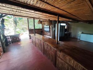 a bar in a restaurant with a wooden counter at Amangwane Tented Camp in Kosi Bay