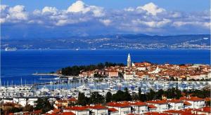 a city with a harbor with boats in the water at Apartments Villa Marittima in Izola