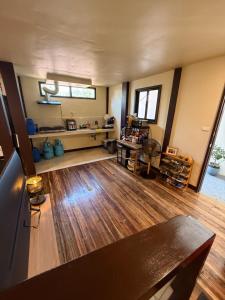 a large living room with wooden floors and a table at Pads Guesthouse in San Vicente