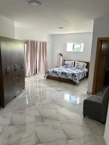 a bedroom with a bed and a large tiled floor at Hotel Pirâmide in Igreja +7 photos