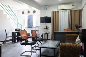 a living room with chairs and a table at Wanderers Backpacker Condotel in Pusok