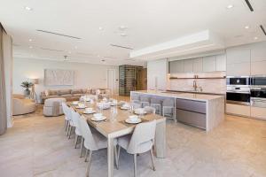 a kitchen and living room with a table and chairs at AQUALINA 1101 PENTHOUSE in Nassau