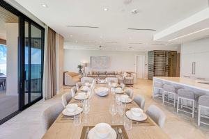 a dining room with a long table and chairs at AQUALINA 1101 PENTHOUSE in Nassau