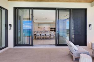 a house with sliding glass doors with a dining room at AQUALINA 1101 PENTHOUSE in Nassau +61 photos