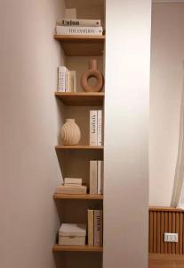 a book shelf filled with books in a room at DEight by The Dream Stays in New cairo +2 photos