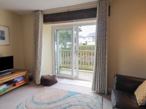 a living room with a sliding glass door at A River Runs By in Staveley