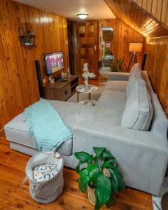 a living room with a couch and a television at Kendi Stays - Rustic Penthouse Attic in Eldoret