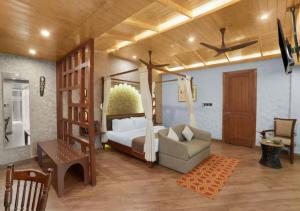 a bedroom with a bed and a couch and a chair at Aureva Shaantam Resorts & Spa - Rishikesh in Rishīkesh +83 photos