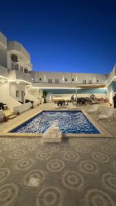 a large swimming pool in the middle of a building at Antika Hotel in Dahab