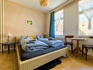 a bedroom with two beds with blue pillows at Pension im Tal der Stille - Thale OT Treseburg in Thale +63 photos