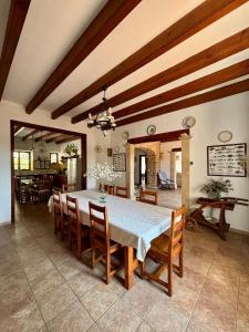 a dining room with a white table and chairs at Finca Es Puig, rustic estate with views in Es Carritxo