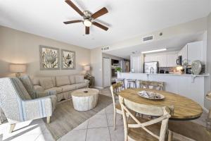 a living room and kitchen with a couch and a table at Beach Club 1109 D in Gulf Shores
