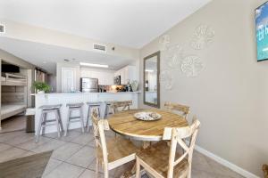 a kitchen and dining room with a table and chairs at Beach Club 1109 D in Gulf Shores +36 photos