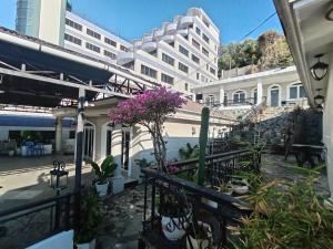 a balcony of a building with flowers and plants at Bai Truoc Hotel in Vung Tau