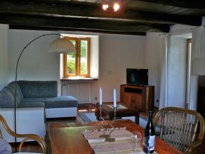 a living room with a couch and a table at Casa Ronco al lago in Pella