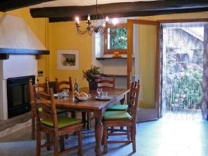 a dining room with a wooden table and chairs at Casa Ronco al lago in Pella