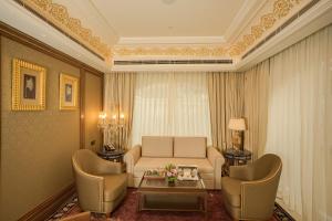 a living room with a couch and chairs and a table at The Leela Palace Jaipur in Jaipur