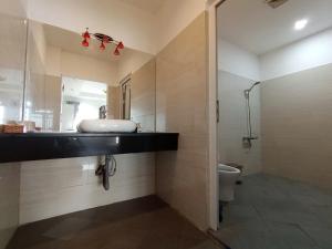 a bathroom with a sink and a toilet at Bai Truoc Hotel in Vung Tau +110 photos