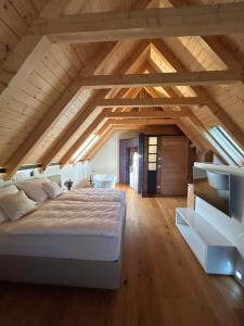 a bedroom with a large bed in an attic at Living & Relax Resorts in Sausal