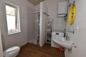 a white bathroom with a sink and a toilet at Schwedenhaus Westensee 1 EG in Groß Vollstedt