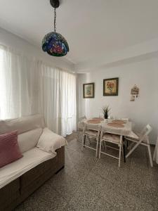 a living room with a couch and a table at Casa de la abuela Tere Caminito del Rey, Valle de Abdalajís, Málaga in Valle de Abdalagís
