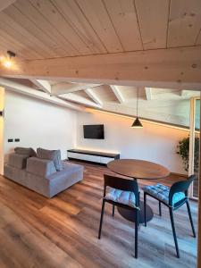 a living room with a table and a couch at Le Calle Holiday Apartments in Nago-Torbole