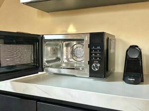 a microwave oven sitting on top of a kitchen counter at Breda Apartment w Kitchen & Private Bathroom 2p in Breda