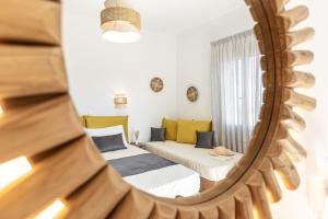 a mirror reflection of a bedroom with a bed at Sunshine in Naxos Chora