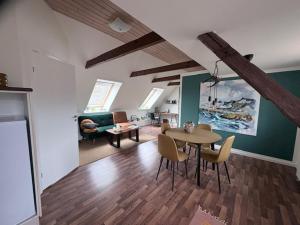 a living room with a table and chairs at Art Apartment Sønderbygaard in Vinderup