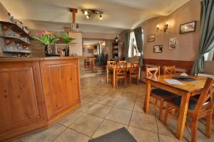 a kitchen and dining room with a table and chairs at Penzion u Nás u Hospůdky in Žatec +27 photos