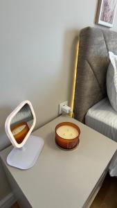 a table with a mirror and a bowl on it at EVA Premium Luxury Apartments - Limak Diamond Residence in Skopje +12 photos