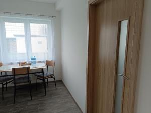 a room with a table and chairs and a window at Apartmán Velký Luh in Velký Luh