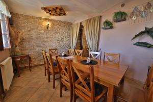 a dining room with a wooden table and chairs at Penzion u Nás u Hospůdky in Žatec