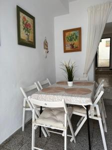 a dining room with a table and chairs at Casa de la abuela Tere Caminito del Rey, Valle de Abdalajís, Málaga in Valle de Abdalagís +19 photos