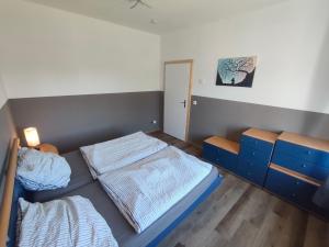 a bedroom with two beds and a door in it at Ferienwohnung Alte Fleischerei in Lauchhammer