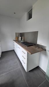 a kitchen with a counter with a laptop on it at Auszeit am Eifeltor in Euskirchen in Euskirchen