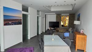 a living room with a table and a couch at Auszeit am Eifeltor in Euskirchen in Euskirchen +2 photos