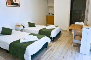 a room with two beds and a desk in it at Casa Sangiorgio Srl in Treviglio