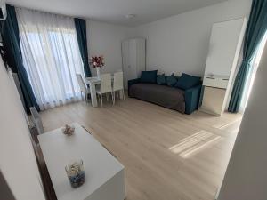 a living room with a couch and a table at Cozy apartment Vama Veche in Vama Veche