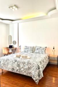 a bedroom with a bed with a silver bedspread at Maison Villa Foch in Meaux