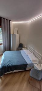 a bedroom with a large bed and two chairs at MarcOrio Apartment in Orio al Serio