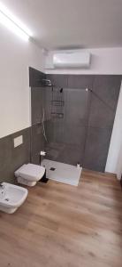 a bathroom with two toilets and a glass shower at MarcOrio Apartment in Orio al Serio