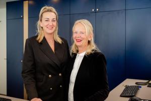 two women standing next to each other in an office at Hotel Asgard in Zinnowitz +46 photos