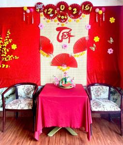 a table with two chairs and a red table cloth at Khách Sạn Á Châu Cần Thơ in Can Tho