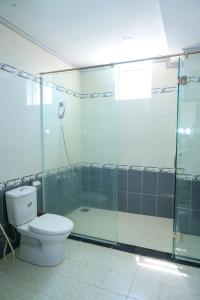 a bathroom with a toilet and a glass shower at Khách Sạn Á Châu Cần Thơ in Can Tho +39 photos