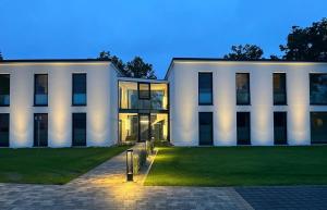 a white building with a lawn in front of it at Apartment "Freya" - DECK9 Am Haff in Garz +56 photos
