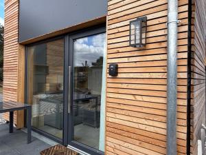 a house with a sliding glass door with a window at Tiny House 2 Dünenblick in Freest