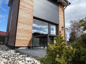 a house with glass doors on the side of it at Tiny House 4 Haffblick in Freest