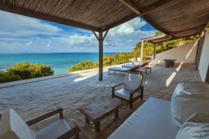 a patio with chairs and a view of the ocean at Mazava Loha Resort in Antsiranana +73 photos
